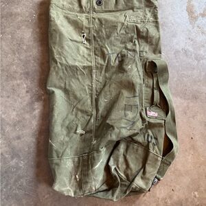 a vintage U.S. military duffel bag Vietnam War era (1960s-1970s).
